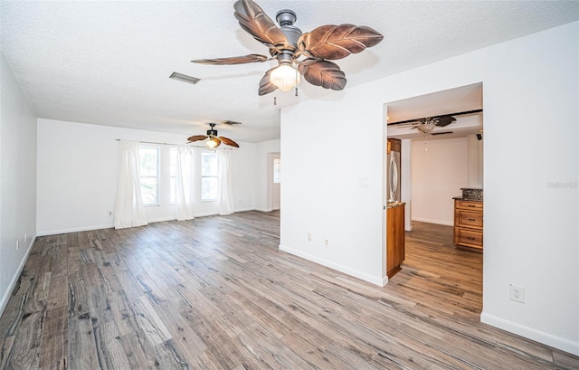 empty room featuring light hardwood / wood-style floors and a textured ceiling