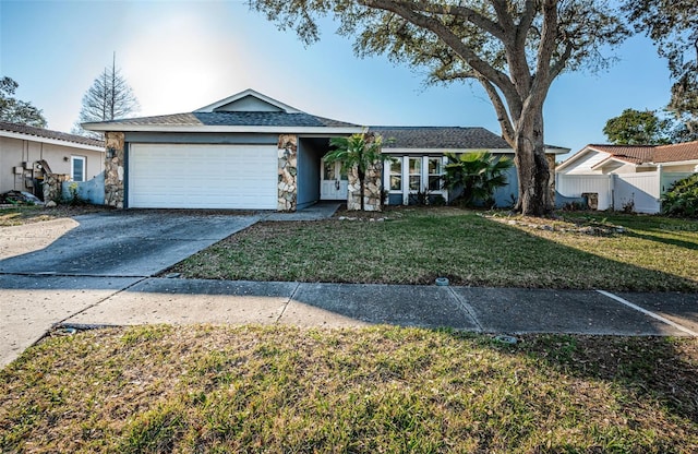 ranch-style house featuring a garage and a front yard