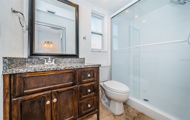 bathroom with vanity, toilet, and a shower with shower door