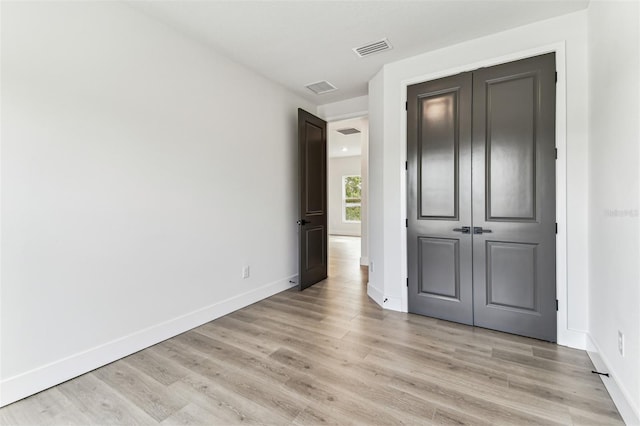 441 42nd Ave NE, Saint Petersburg, FL 33703 - unfurnished bedroom featuring light wood finished floors and a closet