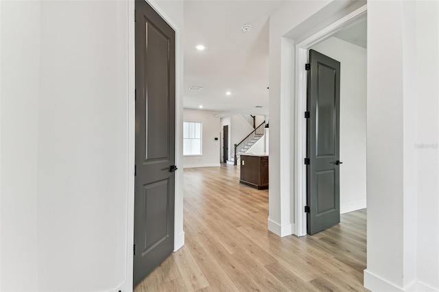 441 42nd Ave NE, Saint Petersburg, FL 33703 - hall with light wood finished floors, stairs, and recessed lighting