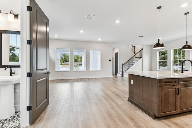 441 42nd Ave NE, Saint Petersburg, FL 33703 - kitchen with light countertops, light wood finished floors, plenty of natural light, and recessed lighting