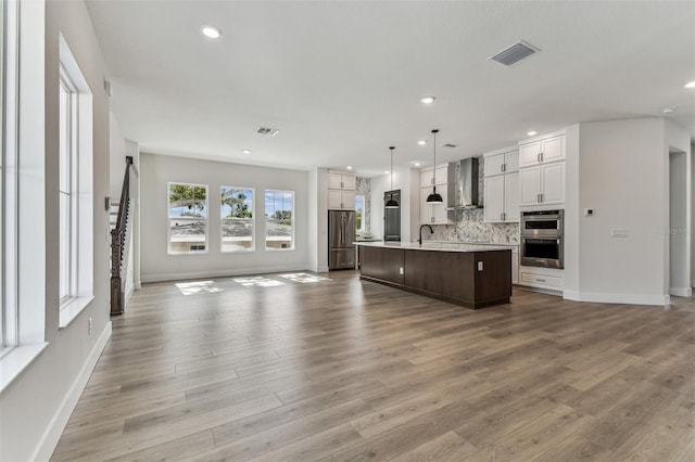 441 42nd Ave NE, Saint Petersburg, FL 33703 - unfurnished living room featuring wood finished floors and recessed lighting