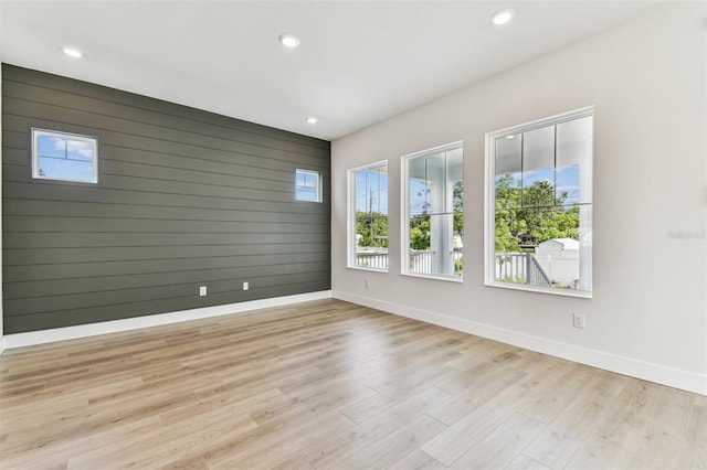 441 42nd Ave NE, Saint Petersburg, FL 33703 - empty room featuring light wood-style floors, recessed lighting, and wood walls