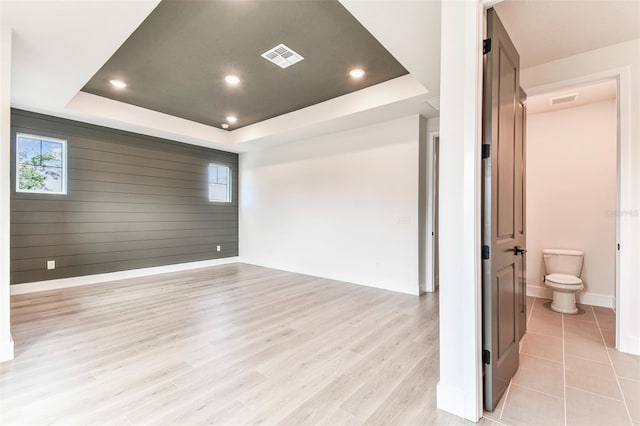 441 42nd Ave NE, Saint Petersburg, FL 33703 - unfurnished room featuring a tray ceiling, healthy amount of natural light, recessed lighting, and light wood-type flooring