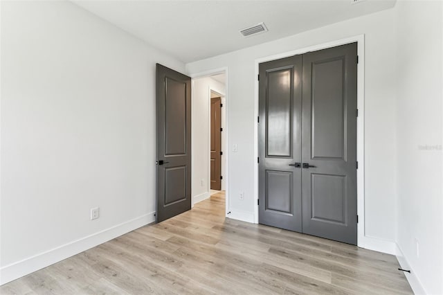 441 42nd Ave NE, Saint Petersburg, FL 33703 - unfurnished bedroom with light wood finished floors and a closet