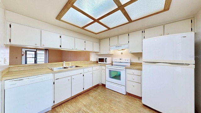 kitchen featuring sink, white appliances, white cabinets, kitchen peninsula, and light wood-type flooring