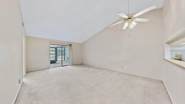 carpeted spare room with high vaulted ceiling and ceiling fan