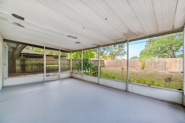 unfurnished sunroom featuring wood ceiling