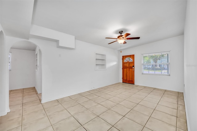 spare room featuring ceiling fan and light tile patterned flooring