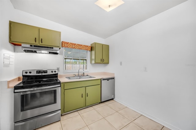 kitchen featuring sink, light tile patterned floors, stainless steel appliances, and green cabinetry