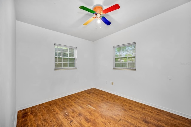 empty room with hardwood / wood-style floors and ceiling fan