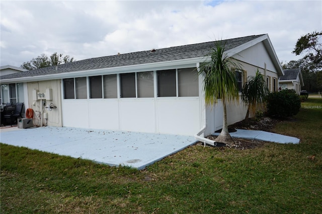 rear view of property with a lawn