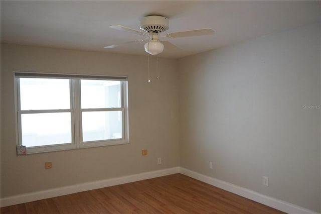 spare room with hardwood / wood-style floors and ceiling fan