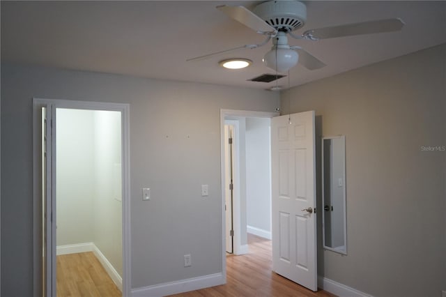 unfurnished bedroom with ceiling fan and light wood-type flooring