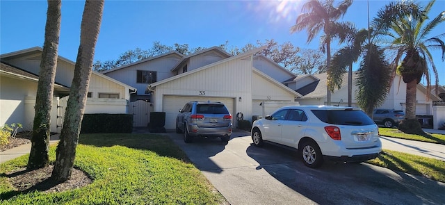 view of side of home with a garage and a lawn