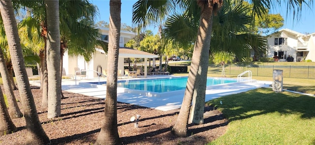 view of swimming pool featuring a patio area and a lawn