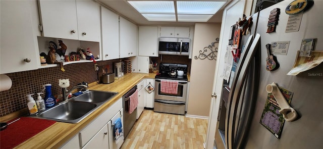 kitchen featuring sink, light hardwood / wood-style flooring, stainless steel appliances, and white cabinets