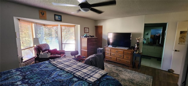 bedroom with wood-type flooring, ceiling fan, and a textured ceiling