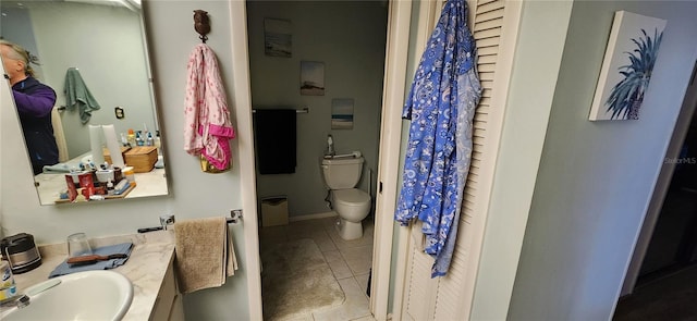 bathroom featuring vanity, tile patterned floors, and toilet