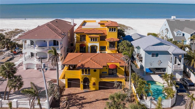 bird's eye view with a water view and a beach view