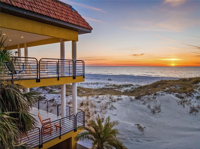 exterior space with a water view and a view of the beach