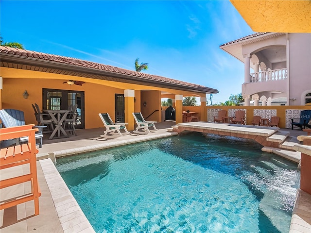 view of swimming pool with a patio area, pool water feature, and ceiling fan