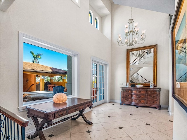 doorway with light tile patterned floors, a wealth of natural light, french doors, and a chandelier