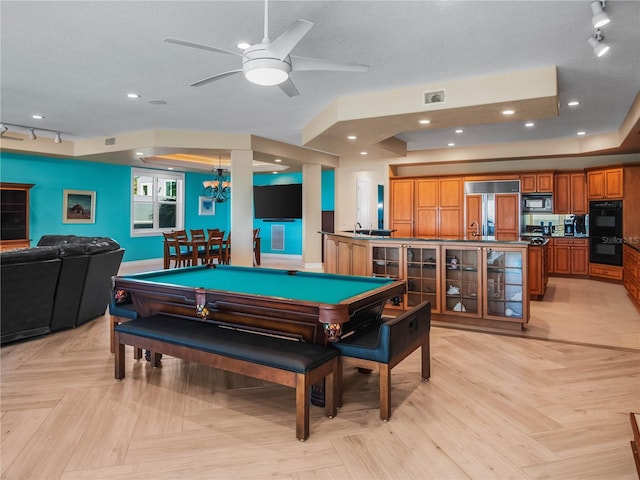 recreation room featuring ceiling fan, light parquet flooring, track lighting, and a textured ceiling