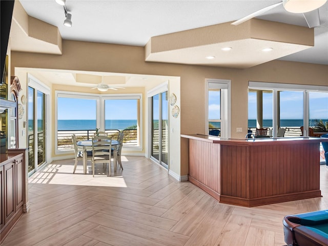 kitchen featuring a water view, ceiling fan, and light parquet flooring