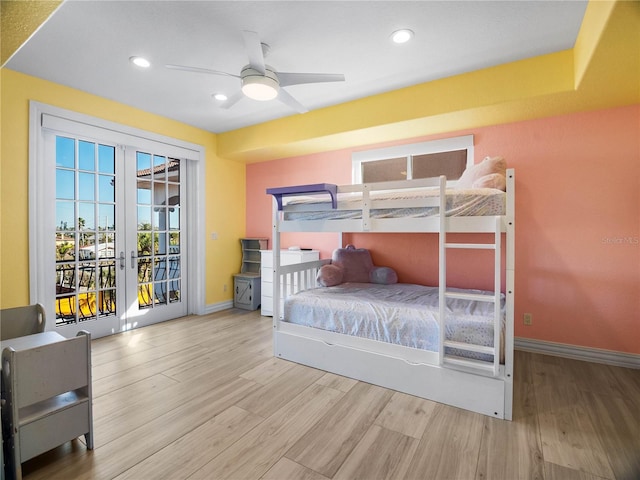 bedroom featuring french doors, ceiling fan, light hardwood / wood-style flooring, and access to outside