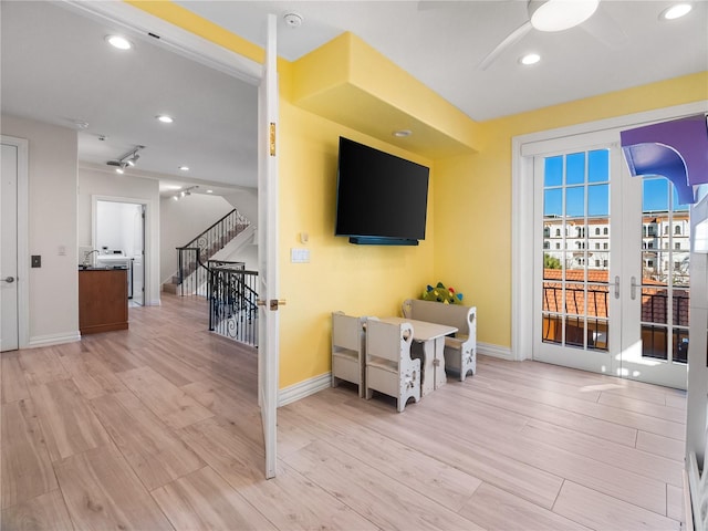 living room with ceiling fan and light wood-type flooring