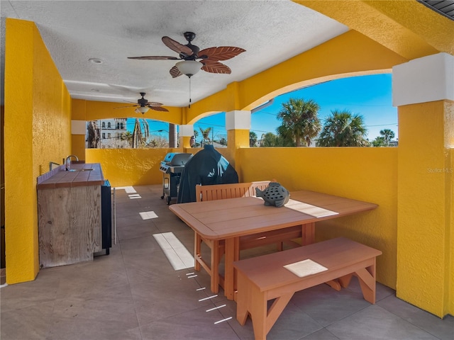 view of patio featuring a grill, ceiling fan, and a wet bar