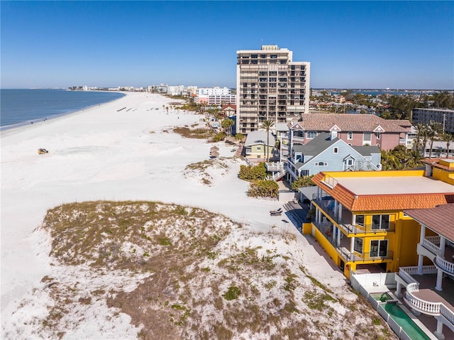 drone / aerial view featuring a water view and a view of the beach