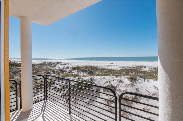 balcony with a view of the beach and a water view