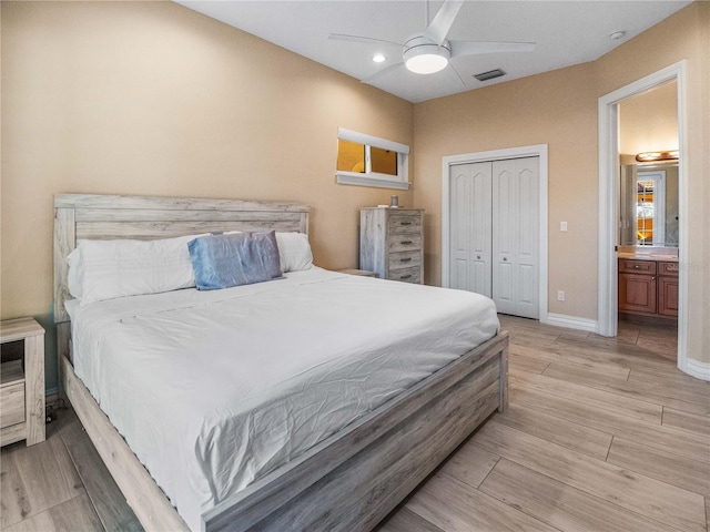 bedroom with light hardwood / wood-style flooring, a closet, and ceiling fan