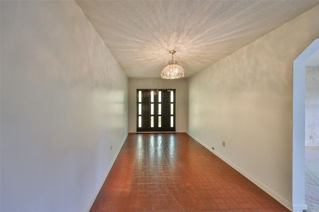 doorway featuring a notable chandelier