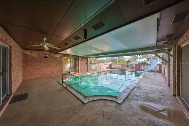 view of pool with a patio, a water slide, and ceiling fan