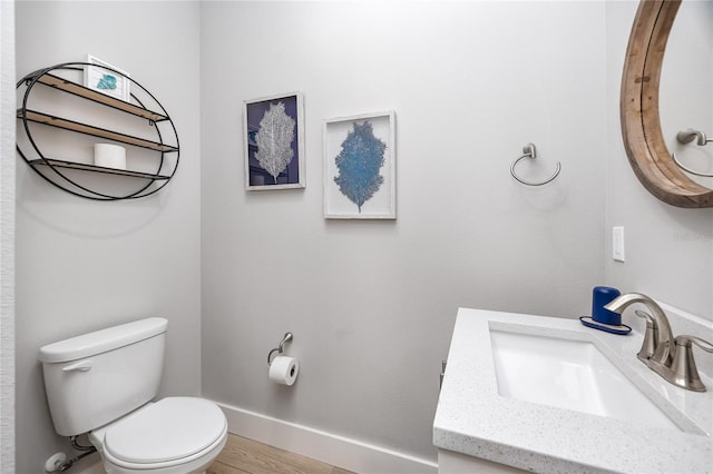 bathroom featuring vanity, hardwood / wood-style floors, and toilet