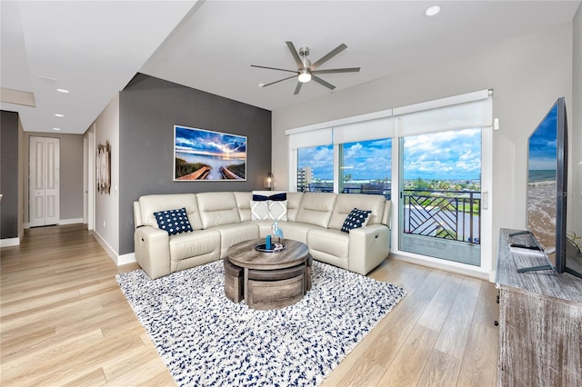 living room featuring ceiling fan and light wood-type flooring