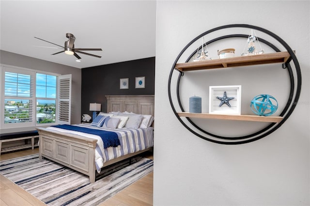 bedroom with light hardwood / wood-style flooring and ceiling fan