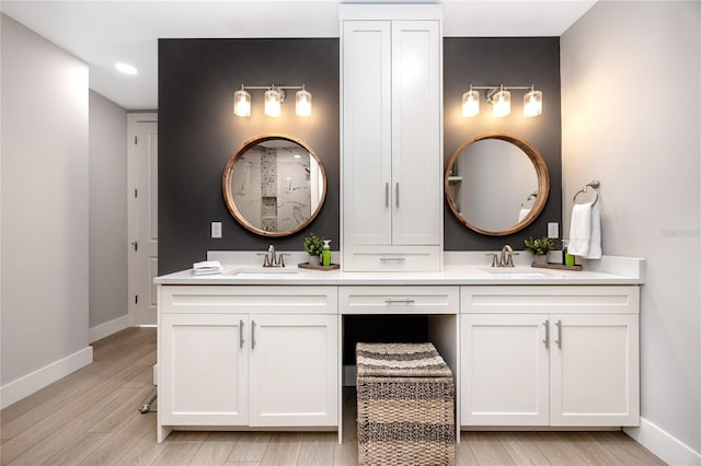 bathroom with hardwood / wood-style flooring and vanity