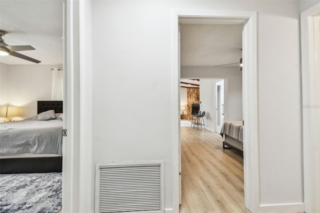 bedroom featuring ceiling fan and light hardwood / wood-style flooring