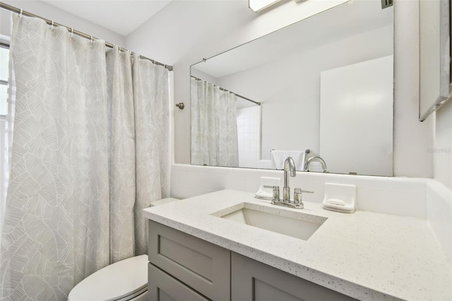 bathroom with vanity, toilet, and walk in shower