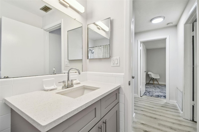 bathroom with vanity and wood-type flooring