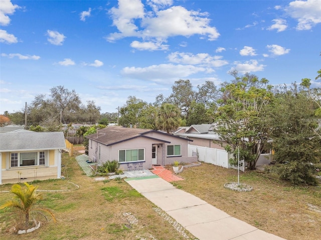 ranch-style home with a front lawn