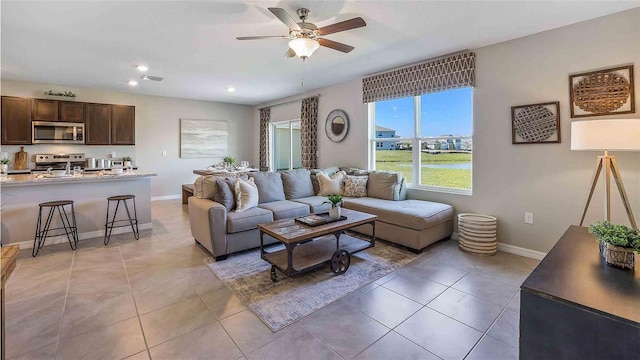 tiled living room with ceiling fan