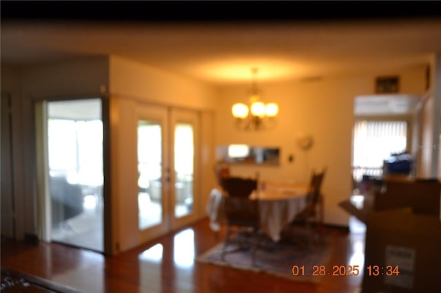 dining area with an inviting chandelier and french doors