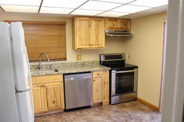 kitchen featuring stainless steel appliances, sink, light brown cabinets, and light stone counters