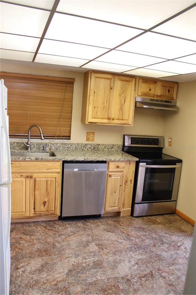 kitchen with light stone counters, stainless steel appliances, and sink